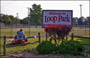 Tom Welsh cuts grass in Loop Park in Walbridge.  The park will be the scene of many of the village's centennial celebration events including the biggest event July 4-6 and a vintage baseball game Aug. 10.