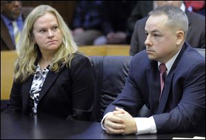 In this March court hearing are Detroit officer Joseph Weekely, right, and A&E producer Allison Howard, who was at the raid.