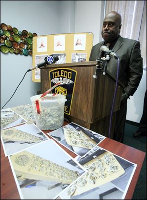 A bucket of mushrooms sits on a table as Toledo Police Chief Derrick Diggs speaks during a September press conference. Toledo’s internal crime statistics are markedly different than those reported to the FBI in 2012 and 2011. And the numbers in the police department’s annual report last year differ from those presented to city council in an April 16 memo written by Chief Diggs.