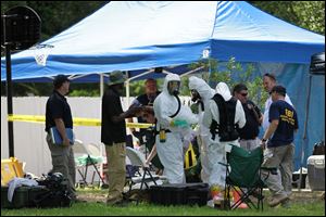 The scene May 31 of an FBI hazardous materials team prepare to enter a residence in New Boston, Texas in connection with a federal investigation surrounding ricin-laced letters mailed to President Barack Obama and New York Mayor Michael Bloomberg. 