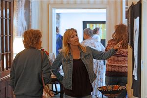 Judy Schramm, left, and Jana Duckett, both of Rossford, make their way past the pieces of fiber art hanging during this year's fiber577 show at the 577 Foundation in Perrysburg. The free show, which ran Saturday and Sunday afternoons, featured 75 pieces, live music, 