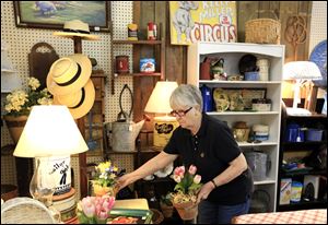 Alice Dewey of Temperance arranges items for sale at the Blissfield Antique Mall.  She’s been selling antiques for 37 years and says Tecumseh, Maumee, and Findlay are rich hunting grounds.