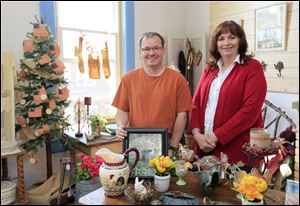 New manager Troy Sebring visits his assistant, Debbie Lake, in her booth at the Blissfield Antique Mall.