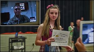 Lillian Harris shares her sixth-grade graduation via Skype with her father, Doug Harris, who is stationed in Afghanistan. Her father is shown in inset.