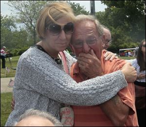 Korean War veteran John Mockenstrum of Maumee and Cindy Sheehan embrace at International Park. She became an icon of the U.S. peace movement after her son was killed in Iraq in 2004.