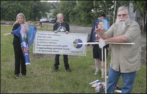 Jeff Zenz, right, of Providence Township speaks at a rally to support Pfc. Bradley Manning. At rear, from left, are Trudy Bond and Steve Miller of Toledo.