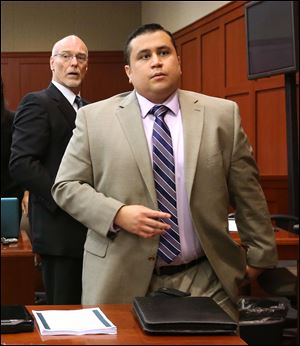 George Zimmerman, right, and attorney Don West, stand as the judge enters the courtroom in Seminole circuit court for a pretrial hearing, in Sanford, Fla., in Saturday. Jury selection begins today.