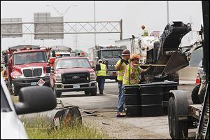 Fire scorched the pavement after the crash on I-75 in North Toledo, but even more damage was caused by unburned fuel soaking into the asphalt and changing its chemical structure. 