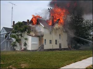 Toledo firefighters battle the blaze at a vacant two-story house on West Bancfroft Street at Warren Avenue.