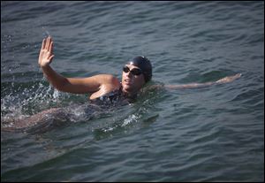 Australian swimmer Chloe McCardel waves to spectators as she begins her swim to Florida from the waters off Havana, Cuba, Wednesday.