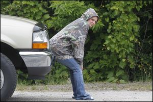 Angela Mories, mother of missing toddler, waits while members of The Toledo Police Dept. search near the Maumee River for Elaina Steinfurth, 1, last week.