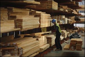 Forklift operator Richard Gascon fills an order of cedar boards at Jones Wholesale Lumber Co. in Lynwood, Calif. Experts say skyrocketing building supply costs may be retreating soon.