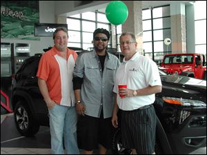 Jeep executive committee members Mark Hepfinger and Mark Garrett, center, chat with new car sales manager Mike Farber of Grogan's Towne Chrysler-Jeep-Dodge.