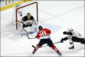 Boston Bruins goalie Tuukka Rask (40) saves a shot by Chicago Blackhawks left wing Brandon Saad (20) during the first period.