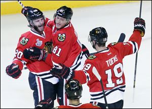 Chicago Blackhawks left wing Brandon Saad (20) celebrates with right wing Marian Hossa (81) and center Jonathan Toews (19) after scoring a goal during the second period Wednesday in Chicago.