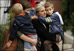 Lauren Brenneman, left, holds her son Isaac Brenneman as friend Valerie Guerin holds her son Stephen Guerin.