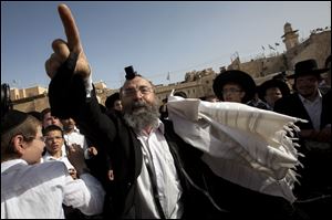 An ultra-Orthodox Jewish man gestures as he protests during a prayer organized by the Women of the Wall.