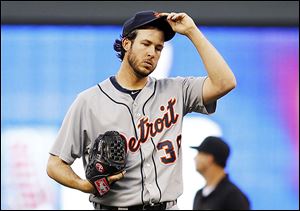 The Tigers’ Darin Downs reacts after the Twins' Joe Mauer hit a two-run single during the sixth inning on Saturday. Downs took the loss after taking over for starter Anibal Sanchez.