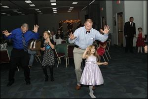 Dads and daughters do the Cupid Shuffle at a dance last fall at Owens Community College.