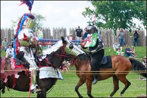 Tom Nader, riding Maggie, left, jousts with his wife, Kim Nader, riding Nemesis, during Muster on the Maumee on Sunday at Fort Meigs in Perrysburg. The Naders live in Greenville, Ohio.