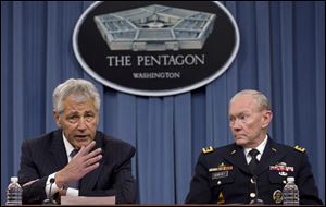 Defense Secretary Chuck Hagel, left, and Chairman of the Joint Chiefs of Staff, Gen. Martin Dempsey back plans to have women able to begin training as Army Rangers by mid-2015, and as Navy SEALs a year later.