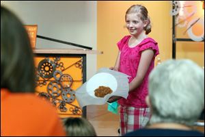 Darby Bryan, 10, of San Francisco, who is visiting her grandmother, shows 'fake, edible barf' that she made with Sylvia Branzei, author of 'Grossology,' at Imagination Station. 