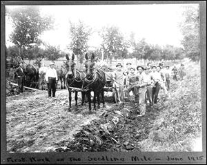 This 1915 photo provided by the Buffalo County Historical Society shows workers in Kearney, Neb., building the 'Seedling Mile' for the Lincoln Highway, to demonstrate the use of concrete as a roadway surface on what was formerly a dirt road. 