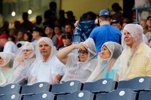 Fans-try-to-stay-dry-as-the