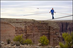 Nik Wallenda nears the completion of his 1400 foot walk across a gorge at the Grand Canyon for Discovery Channel's Skywire Live With Nik Wallenda on Sunday at the Grand Canyon, Calif.