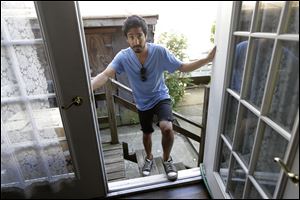 Joseph Ferlito, 25, a resident of Lindenhurst, N.Y., poses at the back door of his Long Island home in Lindenhurst, N.Y.  Ferlito said his community banded together in the weeks after Superstorm Sandy and said FEMA was 