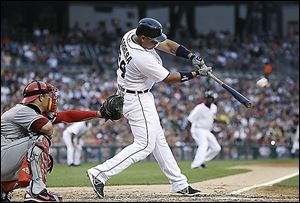 The Angels’ Mark Trumbo scores on a Josh Hamilton single as Detroit catcher Bryan Holaday can't handle the throw in the fifth inning.