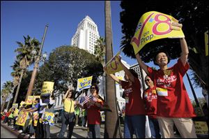 FILE - This Nov. 2, 2008 file photo shows supporters of Proposition 8, the state’s measure that banned same sex marriages, in front of city hall during a Yes on Prop. 8 rally  in Los Angeles. The U.S. Supreme Court is expected to issue a ruling that will determine the fate of California's voter-approved ban on same-sex marriages on Wednesday morning, June 26, 2013. (AP Photo/Mark J. Terrill, File)