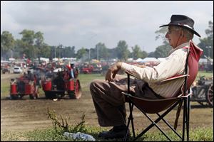 David Pence of Bluffton, Ind., sits on a rise to watch the action.