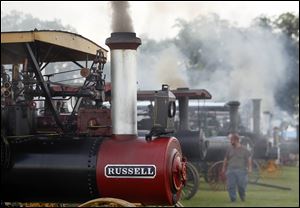 Greg Bechtold of Lancaster, Pa., surveys steam engines at the National Threshers Association’s 69th reunion that runs through Sunday at the  Fulton County Fairgrounds near Wauseon. This year’s featured steam engine is the Keck Gonnerman. Few of those were made.