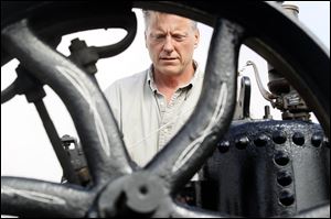 Philip Zuver of the Bryan area works on his 1920 Port Huron steam traction engine during the threshers’ 69th reunion.