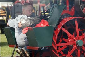 Tennessee resident Ethan Brown, 10, tends to his steam engine.