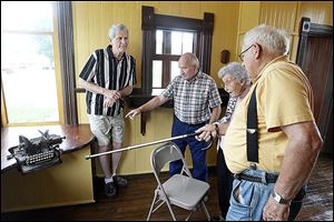 Louisa Strock points to the Oliver Standard Visible typewriter that her father, John S. Mires, used at the Liberty Press newspaper in the early 1900s, to sesquicentennial committeemen, from left, Roger Fisher, John Eckenrode, and John Swearingen at Wabash Depot  in Henry County’s Liberty Center.