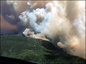 Smokerises from the Silver Fire in in southern New Mexico's Gila National Forest. Fire officials say the Silver Fire, expanded Wednesday to nearly 133 square miles. Meanwhile, in Arizona, a one square-mile wildfire burning in a central Arizona community has led to the evacuation of 50 homes that are threatened by the blaze.