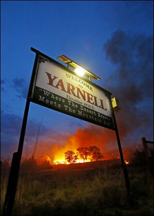 A wildfire burns homes in Yarnell, Ariz. on Sunday. The fire started with a lightning strike on Friday and spread to 2,000 acres on Sunday amid triple-digit temperatures. 