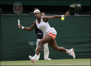 Serena Williams of the United States returns to Sabine Lisicki of Germany during a Women's singles match at the All England Lawn Tennis Championships in Wimbledon, London, today.