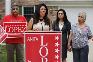 Anita Lopez, Democratic candidate for mayor of Toledo, discusses her personal finances during a news conference in front of her home on Belvedere Drive in Toledo on today. Behind her are friend Lupita Cool, and her mother, Minerva Lopez.