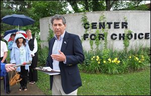 Ed Sitter, executive director of Greater Toledo Right to Life, speaks during a news conference outside the closed Center for Choice in Toledo.  Sitter praised Gov. John Kasich's signing of the new Ohio budget, which the group says is the most pro-life budget in Ohio's history.  