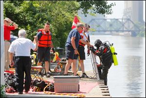 A diver from the Toledo Fire Department finishes a search on the Maumee River. 