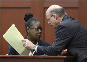 Assistant state attorney Bernie de la Rionda, right, talks to Sybrina Fulton, Trayvon Martin's mother, on the stand during a recess in George Zimmerman's trial in Seminole circuit court, today in Sanford, Fla. 