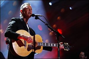 FILE - In this June 7, 2013 file photo, Randy Travis performs on day 2 of the 2013 CMA Music festival at the LP Field in Nashville, Tenn. Travis has been hospitalized in Texas with viral cardiomyopathy. A news release from the singer's publicist says Travis was admitted to the hospital Sunday, July 7, 2013, in Dallas. (Photo by Wade Payne/Invision/AP, File)