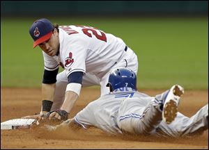 Cleveland Indians second baseman Jason Kipnis tags out Toronto Blue Jays' Jose Reyes, who was trying to stretch a hit into a double in the sixth.