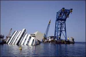 The Costa Concordia Ship wreck lies on its side in the Tuscan Island of Isola del Giglio. Salvage crews are working against time to right and remove the shipwrecked Costa Concordia cruise ship, which is steadily compressing down on itself from sheer weight onto its granite seabed perch.