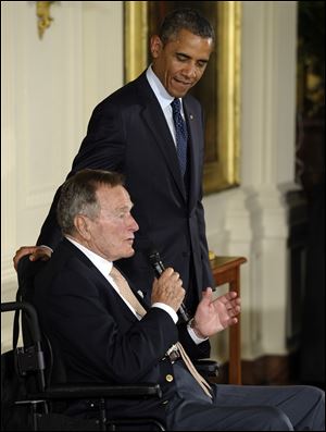 President Barack Obama welcomed George H.W. Bush to the White House in a salute to public service and to the drive for volunteerism that the 41st president inspired with his 