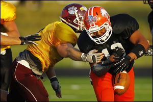 Michael Welch of the Gold team knocks the ball loose from Jovan Palin of the Black team during the 23rd annual Northwest Ohio Regional All-Star Football game.