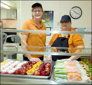 Debra Wissinger, head manager, left, and MaryJo Ireland, kitchen assistant, right, at Fort Meigs Elementary School.